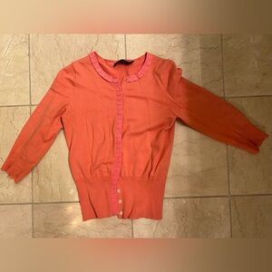 The limited cardigan. Coral color. Fitted to the waist. Size XS.